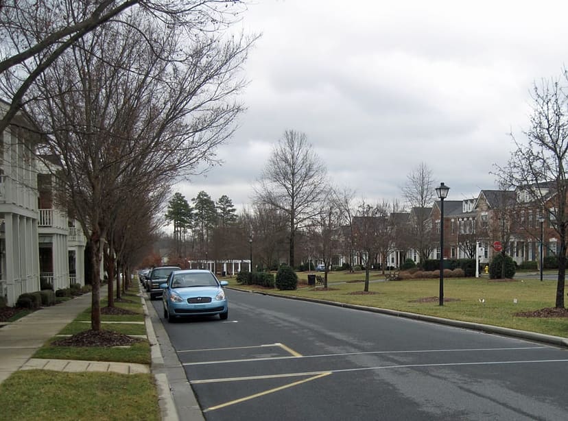Landscaped residential boulevard and public green at Faulkner Square Park in Davidson