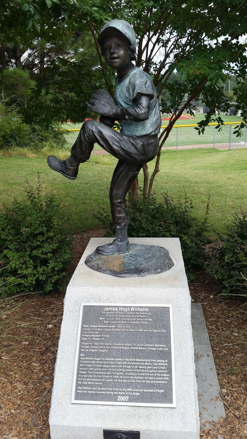 James Hoyt Wilhelm baseball statue with an athletic field behind it at Huntersville Athletic Park