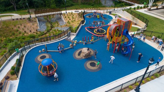 Aerial view of Liberty Park's colorful three-tier playground and accessible paths