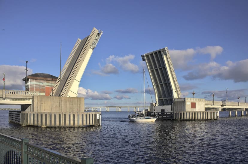 Raised Riverwalk drawbridge and sailboat viewed from the waterfront railing at Union Point Park
