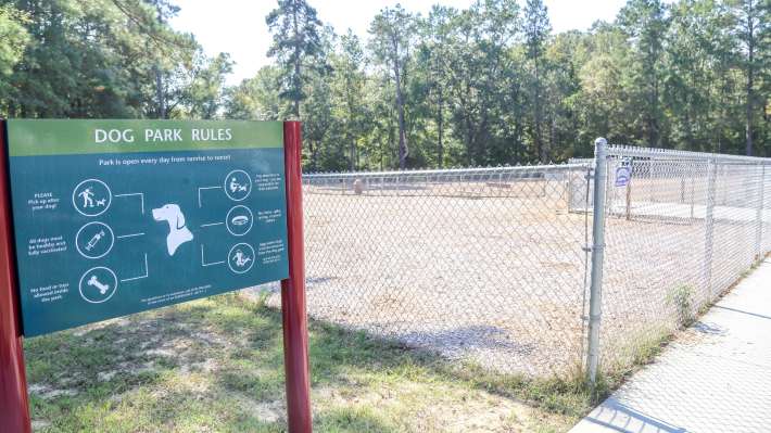 Fenced Buffaloe Road Dog Park and official rules sign