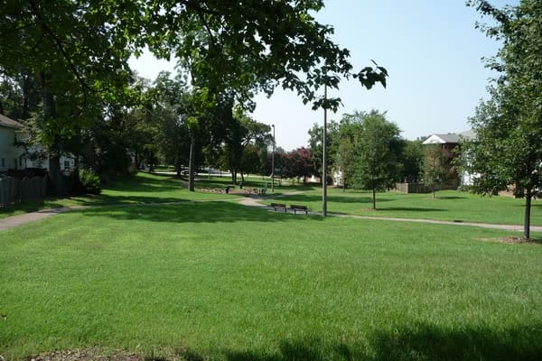 Lawn, paved paths, benches and trees at John Winters Park in Raleigh