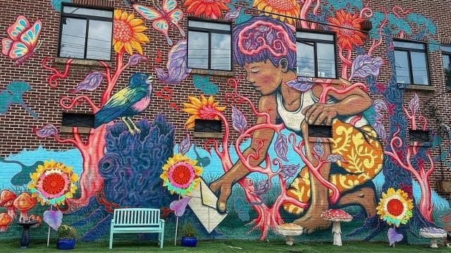 Raleigh's Smallest Park beneath the colorful Parks for the People mural
