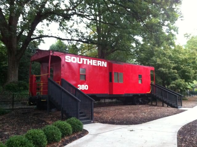 Southern Railway caboose beside the Pullen Park children's railroad