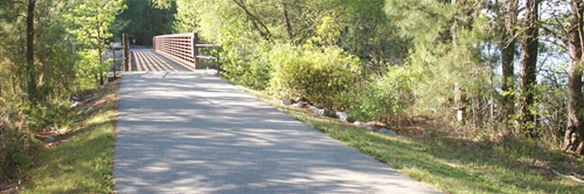 Paved Atlantic and Yadkin Greenway approaching a trail bridge