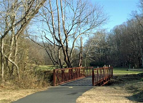 Red bridge at the northern terminus of Muddy Creek Greenway