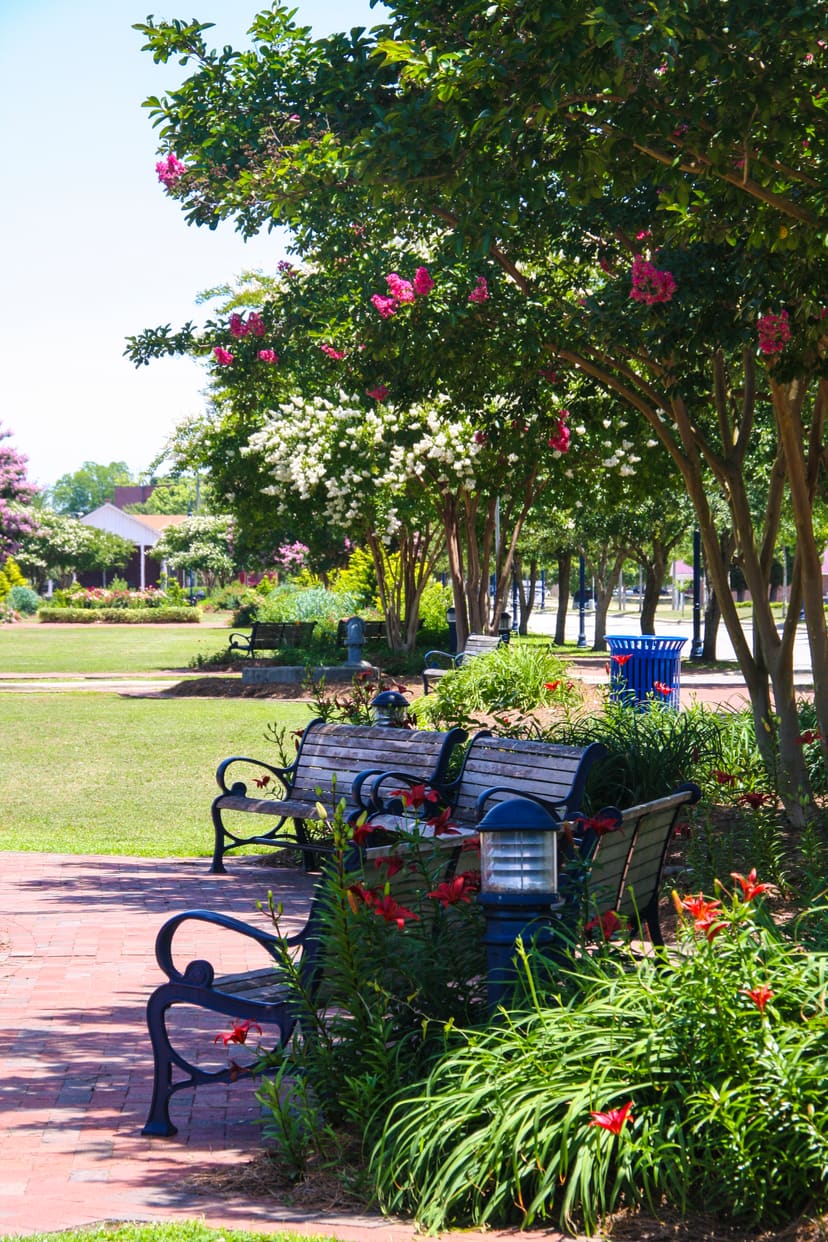 Brick walkways, benches, and flowering gardens at Riverwalk Crossing Park