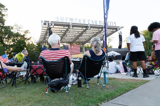 Audience gathered on the Festival Park lawn facing the main stage