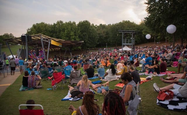 Audience seated on the lawn at the outdoor Bryan Theater