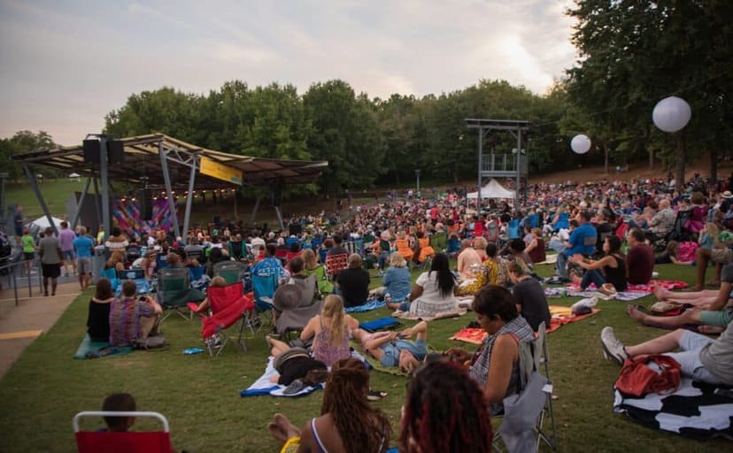 Audience seated on the lawn at the outdoor Bryan Theater