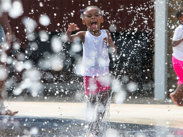 Child playing in the Keeley Park sprayground